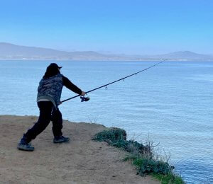 Fisherman casting off Weber Point at China Camp by Harriot Manley